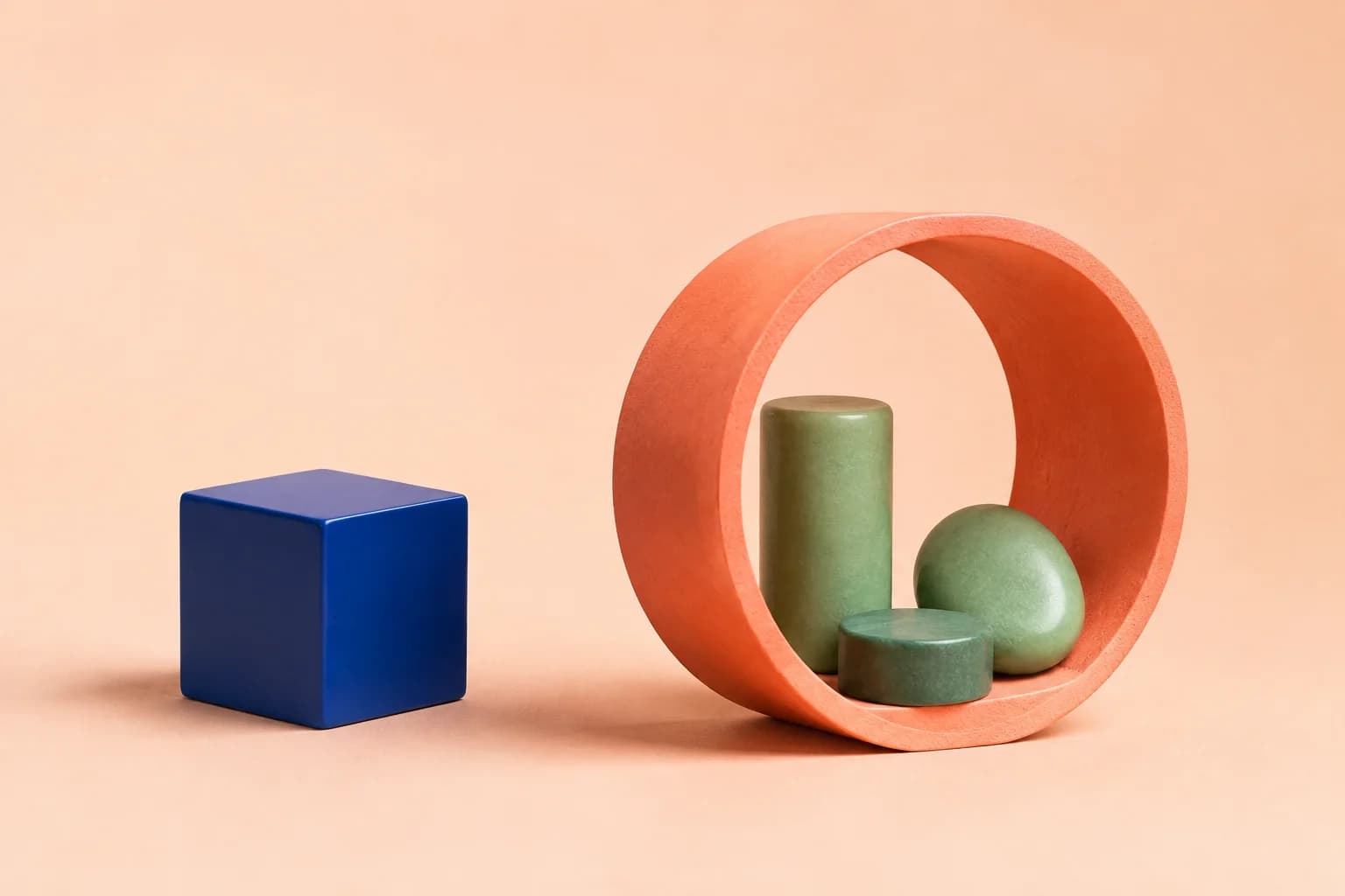 A blue cube beside a coral enclosure holding a small collection of green objects.