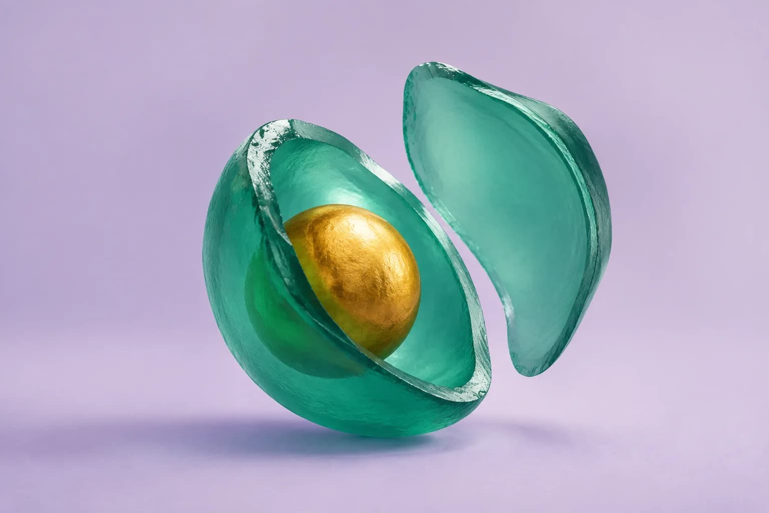 A golden core held within two translucent green shells on a lavender background.